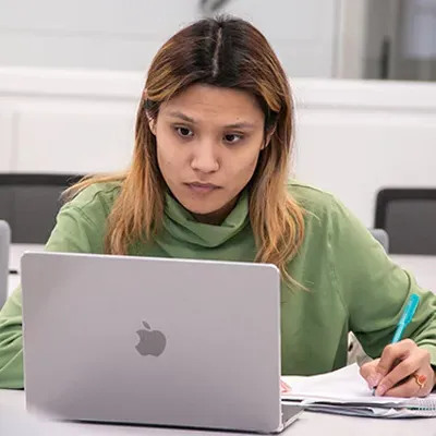 a student works on a laptop